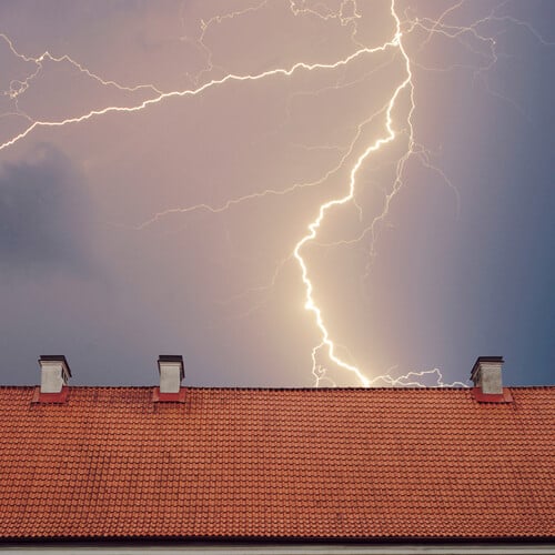 Thunderstorm with lightening over the roof at night